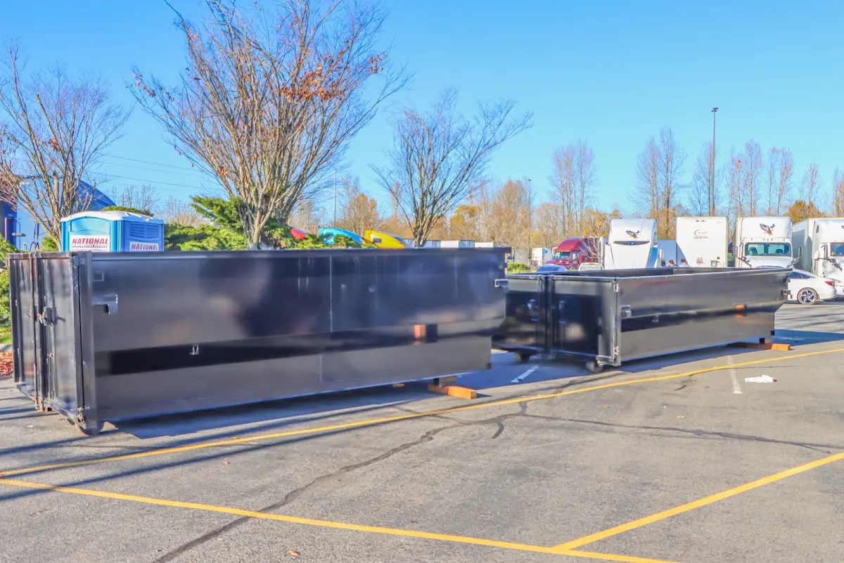 Professional dumpster rental service with roll-off container on residential driveway in Roanoke Rapids